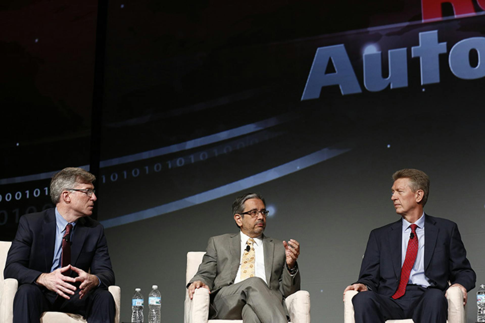 Blake Moret (left), senior vice president for Rockwell Automation, engages with customers during a panel discussion at Automation Fair 2015 about smart technology and data analytics for process optimization.