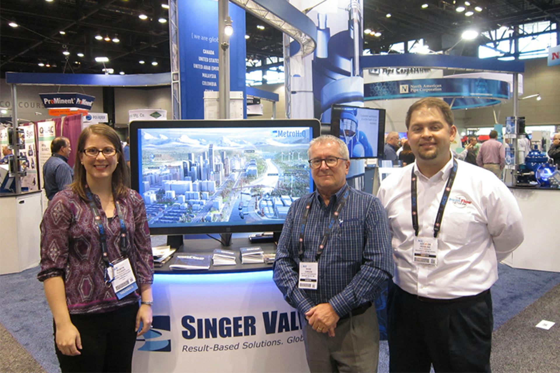 Flow Control Editor in Chief Robyn Tucker (left) and Account Executive Addison Perkins (right) with Singer Valve&rsquo;s Mark Gimson (center) at AWWA ACE16.