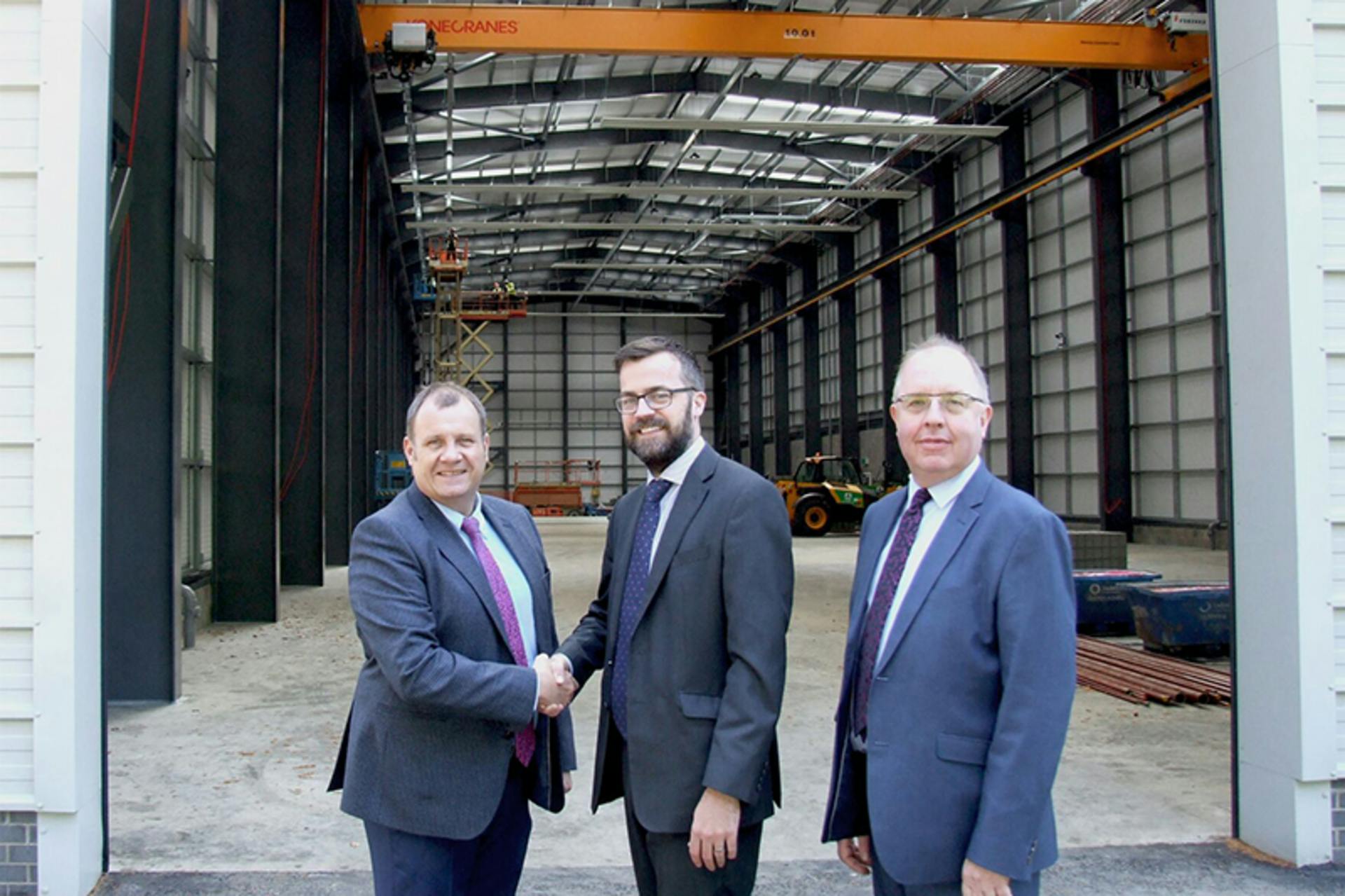 TUV NEL&rsquo;s completed base building that will house its Advanced Multiphase Facility. Pictured from left to right: Brian Austin, CEO, TUV SUD U.K. & Ireland; Matt Bellshaw, property director &ndash; HFD Property Group Limited; William McKnight, chief financial officer, TUV SUD U.K. & Ireland. Graphic courtesy of TUV SUD NEL