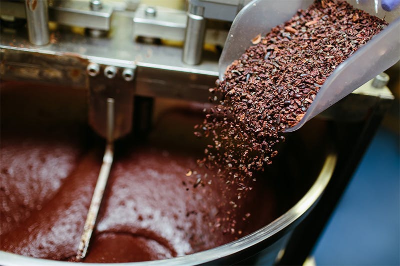 Cocoa grits are added into the chocolate-making process. primipil/iStock