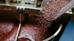 Cocoa grits are added into the chocolate-making process. primipil/iStock