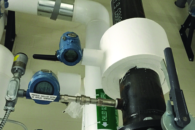 Image 1. This application&rsquo;s temperature-measuring instrument is installed next to a conventional temperature transmitter with an externally mounted WirelessHART adapter for comparison purposes only. The insulation around the new measurement-technology installation creates a one-dimensional heat flow profile, allowing compensation for varying ambient and process temperature conditions to produce a corrected internal process temperature, which is then wirelessly communicated. | All images courtesy of Emerson Process Management