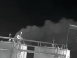 Oil and gas industry worker on tank catwalk and inside gas leak from open thief hatch. Oil and gas industry worker on tank catwalk and inside gas leak from open thief hatch.