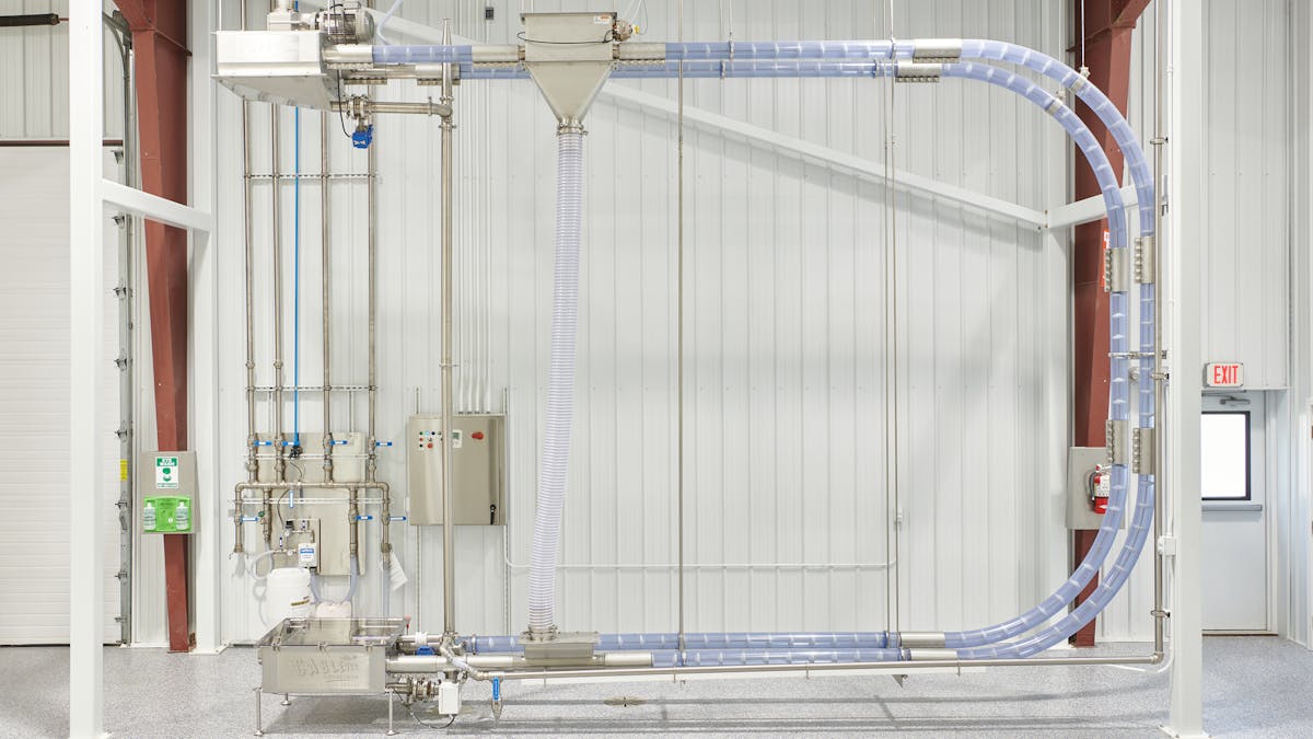 Tubular cable conveyors move product through a sealed tube using a coated, flexible stainless-steel drag cable pulled through on a loop. Solid circular discs are attached to the cable, which push the product at low speed through the tube without the use of air, preserving product integrity and minimizing waste.