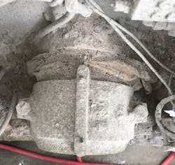 Figure 4: The cement mixer before the air seal. Notice the cement leakage between the asset and bearing (top). Below, the housekeeping team tried to chip away some of the hardened cement.