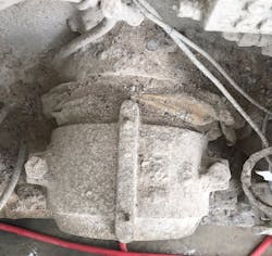Figure 4: The cement mixer before the air seal. Notice the cement leakage between the asset and bearing (top). Below, the housekeeping team tried to chip away some of the hardened cement. Figure 4: The cement mixer before the air seal. Notice the cement leakage between the asset and bearing (top). Below, the housekeeping team tried to chip away some of the hardened cement.