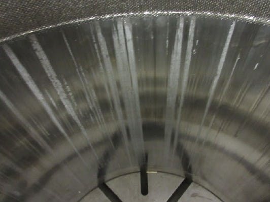 Figure 4: Tiny metal pellets from a failed upstream media filter were trapped between the valve cage and the plug, rendering the valve immobile. It took a hydraulic press to pull the plug out of the cage, leaving long score marks in the valve cage.