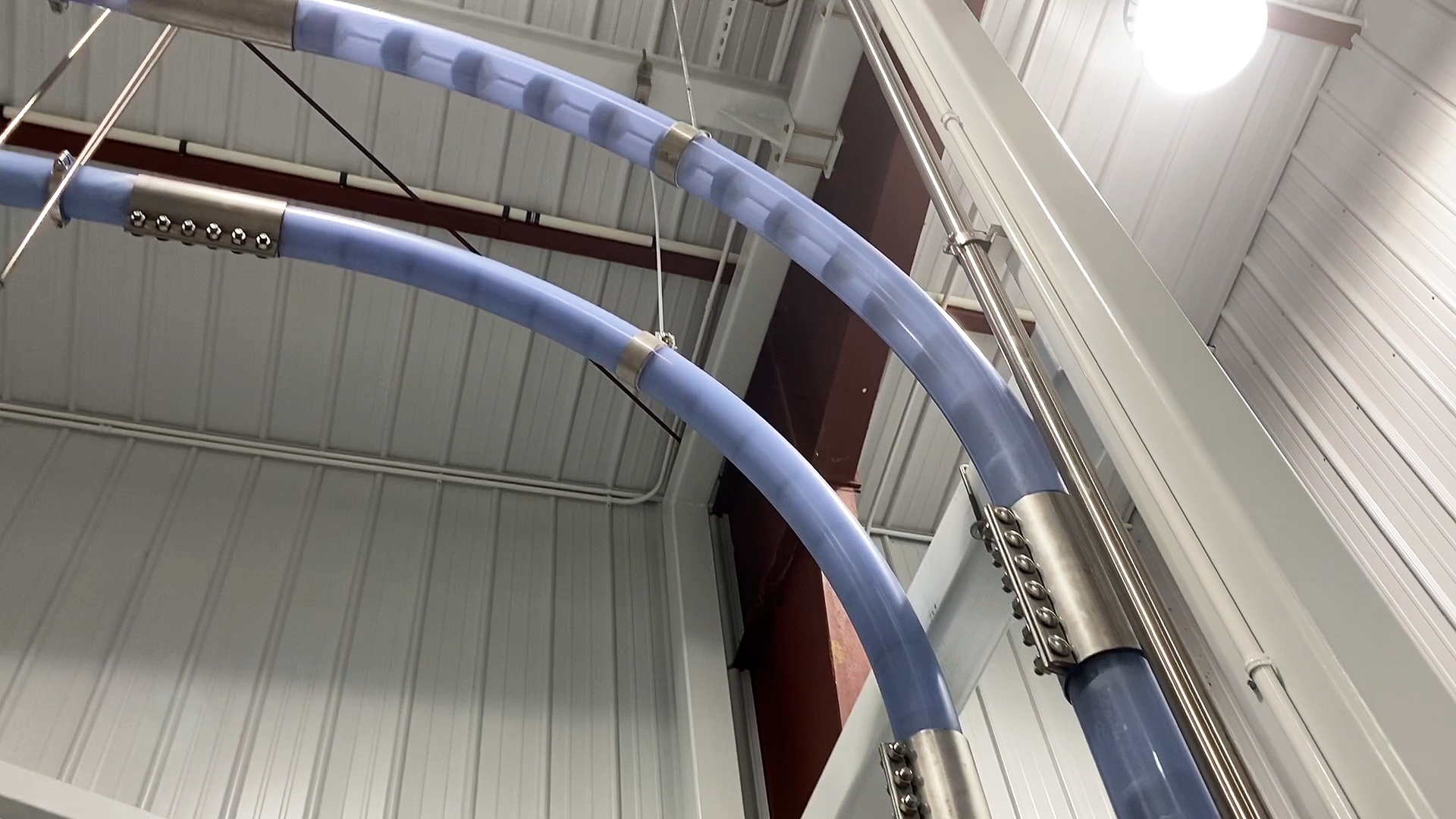 Figure 1: The Cablevey Conveyors tubular conveyor is clear except for the clamps so staff can visually check at any time. A unique cleaning inspection option involves a small, lighted camera system, with video inside the tubes viewable on a smartphone via an app.