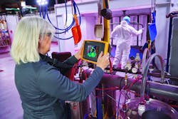 A worker using a Fluke ii900 Sonic Industrial Imager. A worker using a Fluke ii900 Sonic Industrial Imager.