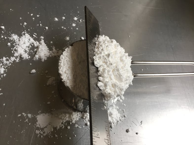 Correct measurement of loose bulk density requires only a few basic tools, including a suitable container, a straight edge or spatula, and a gram balance.