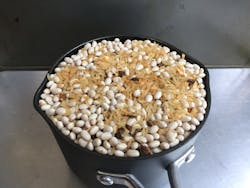To minimize segregation in free-flowing mixtures such as the rice and beans shown here, transfer the mixture into the measuring container using a spoon and thoroughly stir the sample before taking each spoonful. To minimize segregation in free-flowing mixtures such as the rice and beans shown here, transfer the mixture into the measuring container using a spoon and thoroughly stir the sample before taking each spoonful.