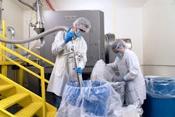 Material enters a vacuum conveyor through a pick-up wand and is discharged through a cyclone separator at the mixer’s stationary inlet. Material enters a vacuum conveyor through a pick-up wand and is discharged through a cyclone separator at the mixer’s stationary inlet.