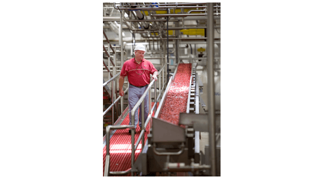 Vibratory conveyors move tacky, sweetened dried cranberries at an incline of almost 10 degrees.