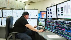 An operator looking at a display from the dataPARC data historian on several monitors. An operator looking at a display from the dataPARC data historian on several monitors.