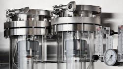 Figure 4: Cap assemblies placed securely on residue tubes make it easier for technicians to fill the tubes with ammonia samples. Figure 4: Cap assemblies placed securely on residue tubes make it easier for technicians to fill the tubes with ammonia samples.