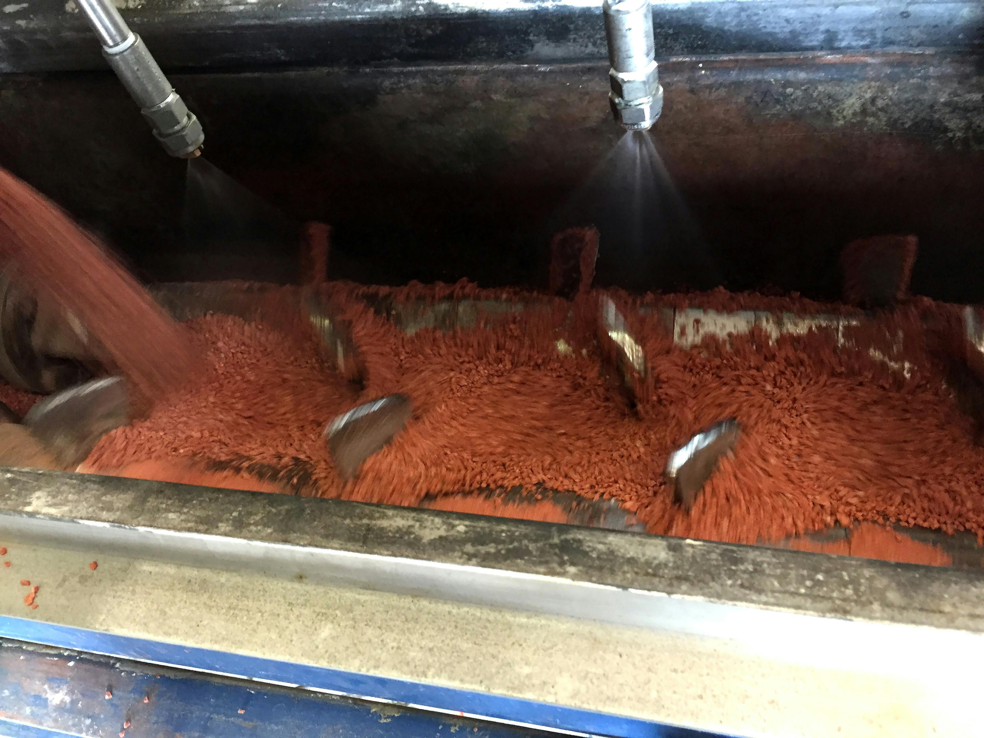 Interior view of a pugmill mixer (with binder spray system) during testing in the FEECO Innovation Center.