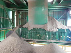 A grated enclosure did not adequately contain spillage from pouring out of the transfer point. A grated enclosure did not adequately contain spillage from pouring out of the transfer point.