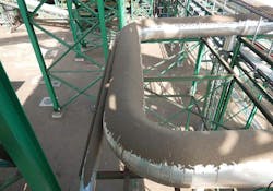 Carryback from insufficient belt cleaning caused spillage to drop along the length of the belt return. Carryback from insufficient belt cleaning caused spillage to drop along the length of the belt return.