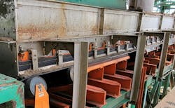 The single long black rubber strip of skirting sits on top of the orange external wear liner plate. The single long black rubber strip of skirting sits on top of the orange external wear liner plate.