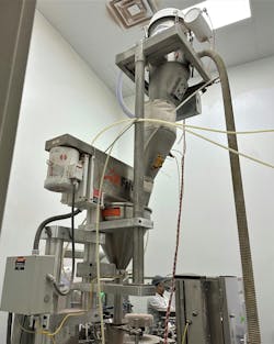 This vacuum conveyor fills an auger-filler packaging machine with constant head pressure of the powder to ensure accuracy of the filled containers. This vacuum conveyor fills an auger-filler packaging machine with constant head pressure of the powder to ensure accuracy of the filled containers.