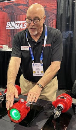 Scott Bonine of BinMaster demonstrates the BMRX-300 rotary level switch. The switch's bright LED turns from green to red to indicate when the bin is full or empty, depending on the setting. Scott Bonine of BinMaster demonstrates the BMRX-300 rotary level switch. The switch's bright LED turns from green to red to indicate when the bin is full or empty, depending on the setting.