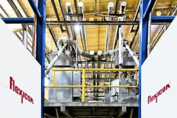 Twin flexible screw conveyors from the bulk bag dischargers connect to horizontally oriented flexible screw conveyors on the mezzanine, feeding sugar to the six juice cookers. Twin flexible screw conveyors from the bulk bag dischargers connect to horizontally oriented flexible screw conveyors on the mezzanine, feeding sugar to the six juice cookers.