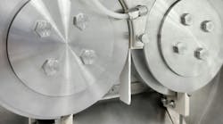 Roll compactor discharging a ribbon of compressed material. Roll compactor discharging a ribbon of compressed material.