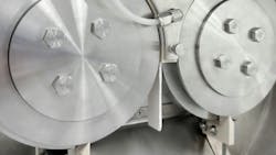 Roll compactor discharging a ribbon of compressed material. Roll compactor discharging a ribbon of compressed material.