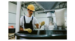 Worker monitoring a mixing process Worker monitoring a mixing process