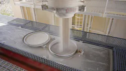 Industrial material flowing from hopper Industrial material flowing from hopper