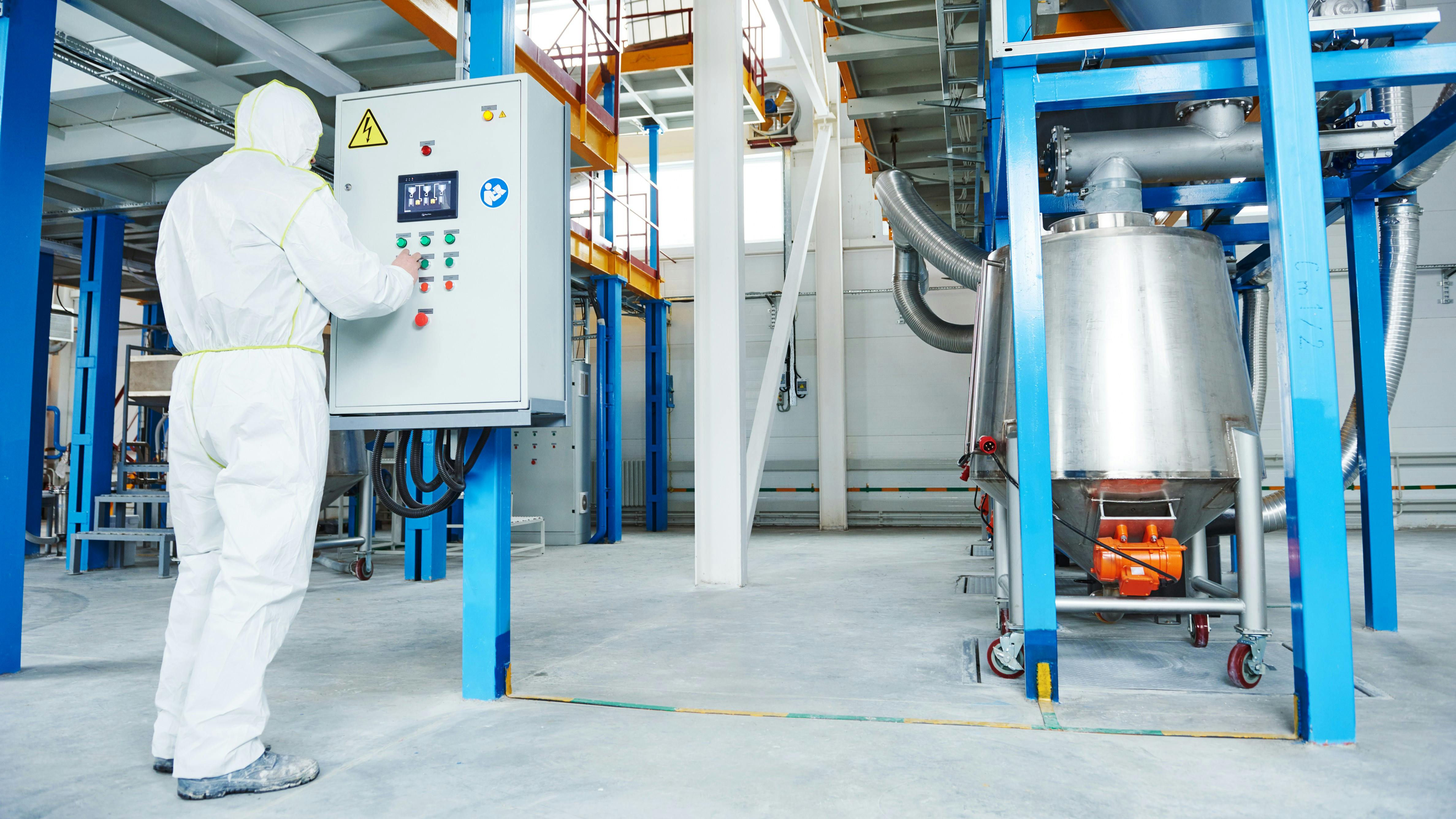 Chemical industry worker at control panel