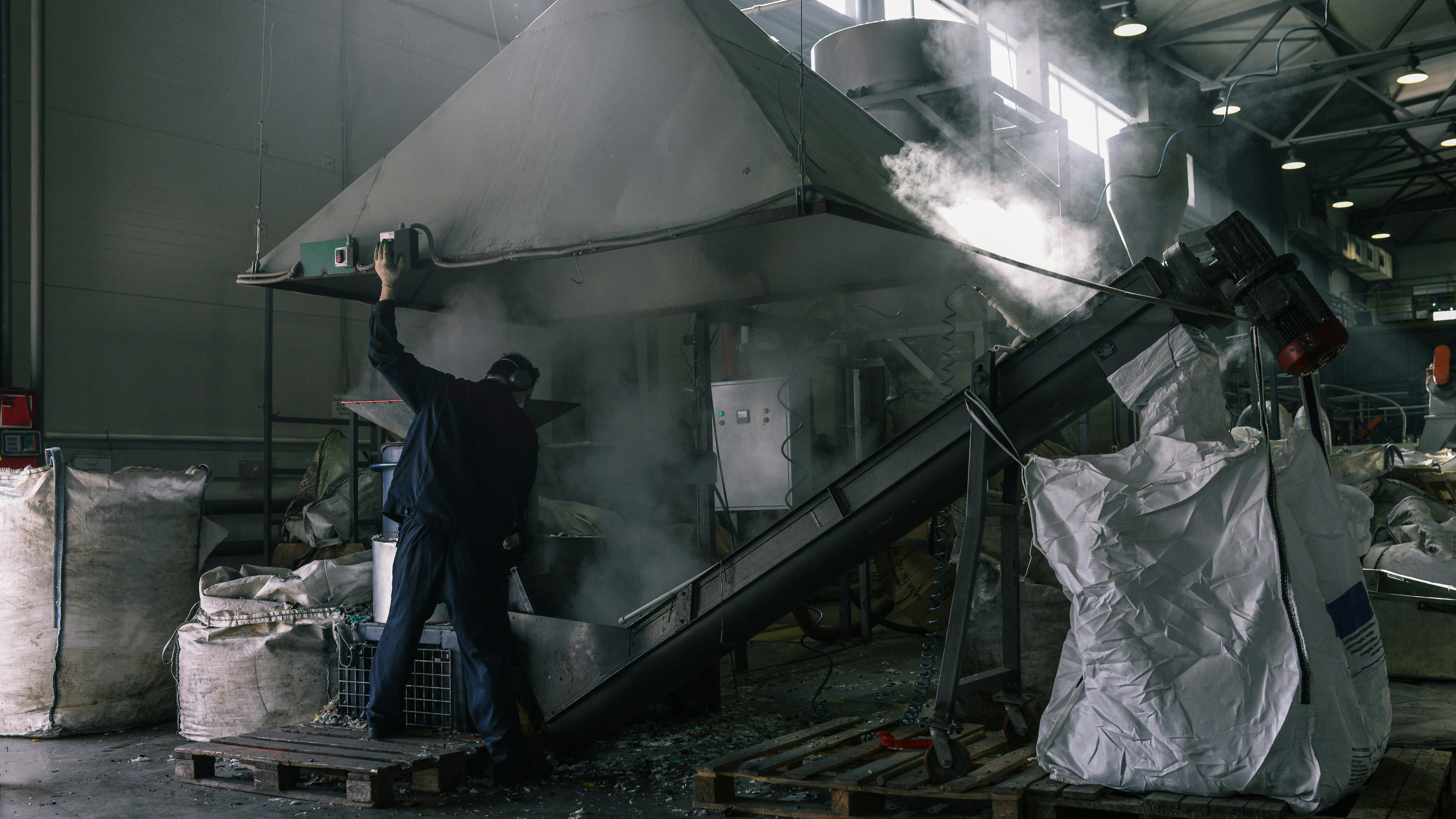 Worker in dusty factory