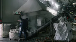 Worker in dusty factory