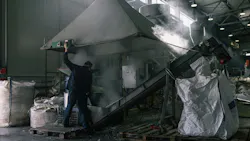 Worker in dusty factory