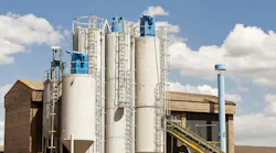 White silos with blue bin vent dust collectors