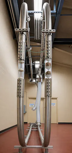 Tubular drag conveyor vertical run with almonds