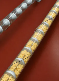 Tubular drag conveyor moving frozen scrambled eggs